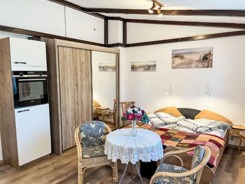 a room with a bed and a table and chairs at Holiday Home Hammel by Interhome in Ostseebad Koserow