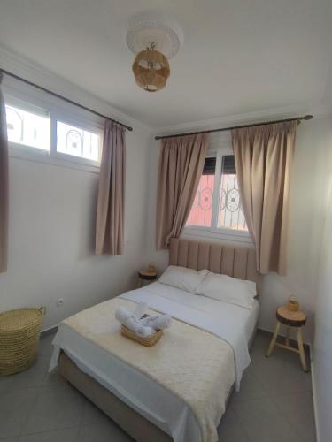 a bedroom with a large bed with a window at Oasis Aglou in Aglou