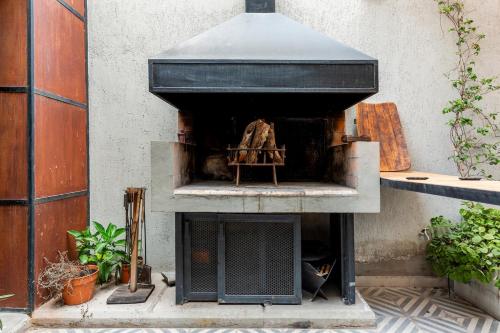an outdoor oven is sitting on the side of a building at Industrial House in Mendoza with Jacuzzi in Mendoza