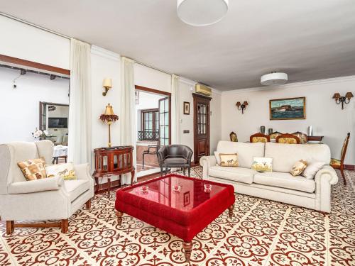 a living room with white furniture and a red coffee table at Holiday Home El patio de Lazaro by Interhome in Fuengirola