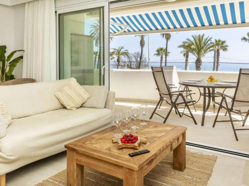 a living room with a couch and a table at Apartment Marinada Cambrils by Interhome in Cambrils