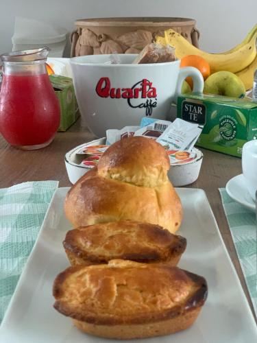 three loaves of bread on a plate on a table at B&B Passione Salento in Surbo