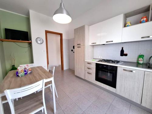 a kitchen with a wooden table and a stove top oven at Casa Iris con splendida vista mare in Torre Vado