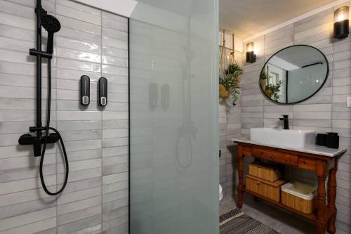 a bathroom with a shower with a sink and a mirror at Toutounis House Kazaviti in Mikros Prinos