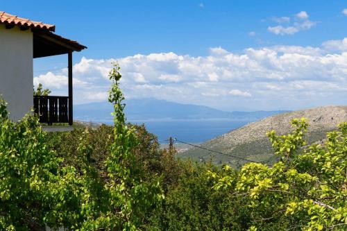 a house on a hill with a view of the ocean at Toutounis House Kazaviti in Mikros Prinos