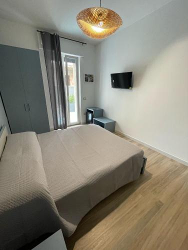 a bedroom with a large bed and a television at Marconi B&B - Holiday Home in Marconia