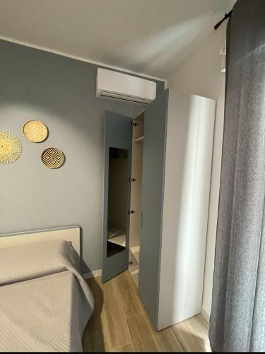 a small bedroom with a bed and a closet at Marconi B&B - Holiday Home in Marconia
