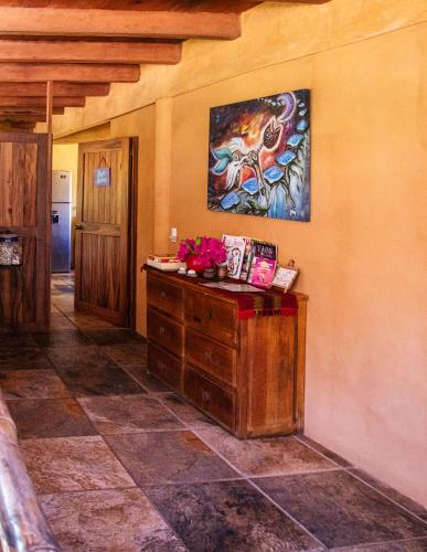 a room with a painting on the wall at Hotel Restaurante Mi Jardin Troncones in Troncones