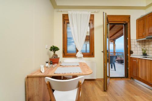 a dining room with a table and a window at Christina's Village Home in Kallirakhi