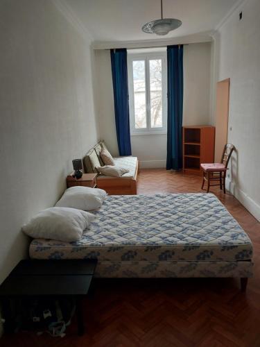 une chambre avec un lit et un canapé dans l'établissement Appartement centre Jausiers, à Jausiers