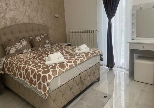 a bedroom with a bed with two towels on it at Apartman Manda 2 in Belgrade