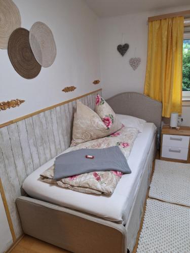 a bedroom with a bed with two pillows on it at Haus Hoogendam in Leoben