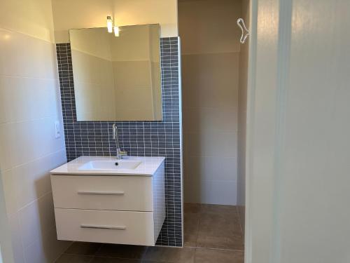 a bathroom with a sink and a mirror at Villa Oliandre in Plan-de-la-Tour