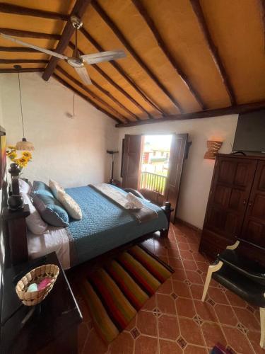 a bedroom with a large bed and a window at AQUI ESTOY BIEN in Barichara