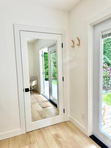 a door with a mirror in a room at Posada Nordica - a chic, tranquil mountainview suite in Hope
