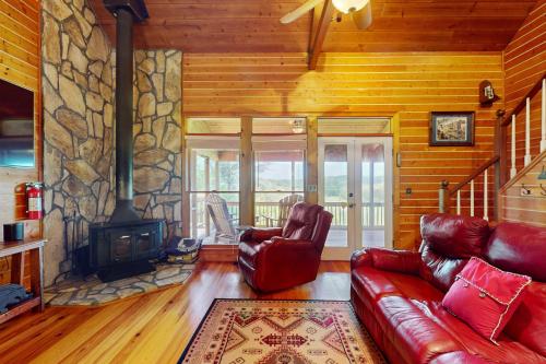 a living room with a couch and a fireplace at Down by the River in Blue Ridge