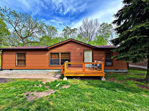 a wooden house with a porch in the yard at Put-in-Bay Island Club #74 in Put-in-Bay