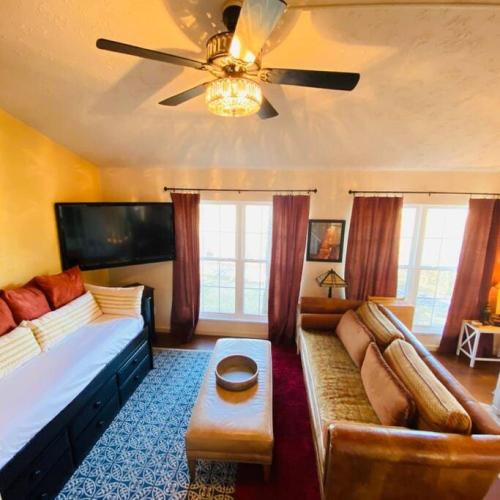 a living room with a couch and a ceiling fan at The Big Chill on Table Rock Lake in Holiday Island