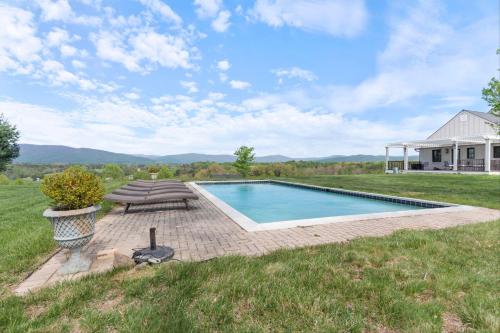 a swimming pool in the middle of a yard at Rustic Baileys Retreat Cabin Near Wineries! in Crozet