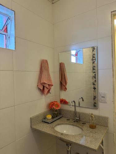 a bathroom with a sink and a mirror at Recanto Paraíso in Cotia