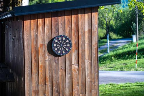 a woodenshed with a dart on the side of it at Tesla's Gastro House Plitvice in Plitvička Jezera