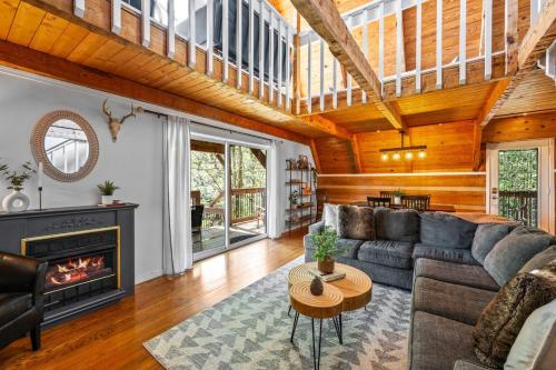 a living room with a couch and a fireplace at Charming A-Frame Cabin w Hot Tub & Mountain Views in Gatlinburg