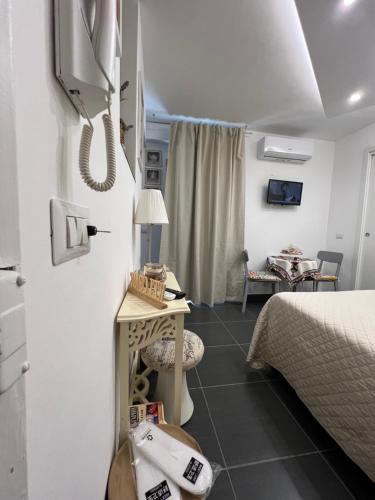 a room with a bed and a phone on the wall at Nel Cortile Suite in Cefalù