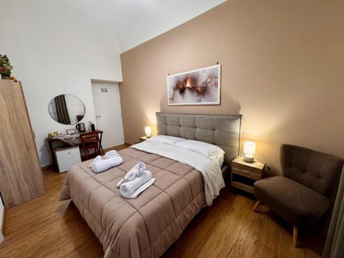 a bedroom with a bed with two towels on it at Pindemonte Pomelia in Palermo
