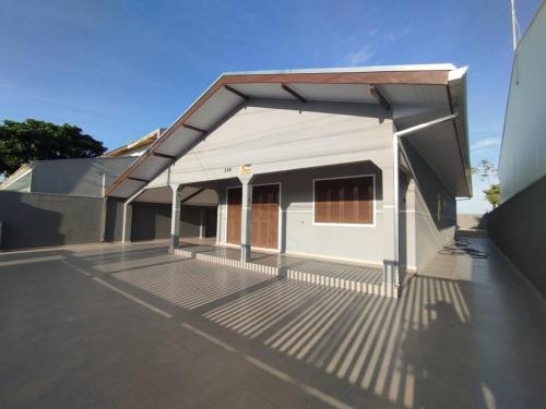 a small white building with a large patio at Casa Brisa do Mar in Pontal do Paraná