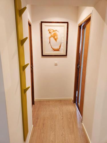a hallway with a painting on the wall at La Maison Sacco in LʼÎle-Rousse