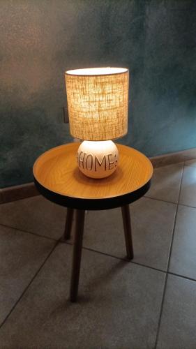 a table with a lamp on top of it at Dimora 99 in LʼAquila