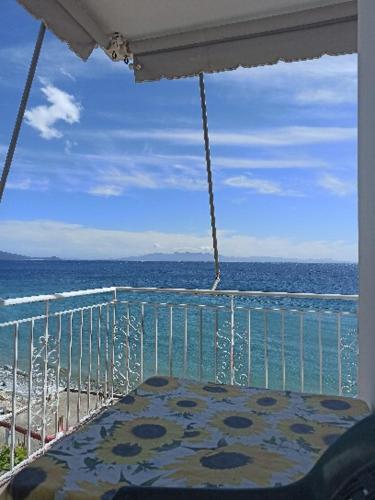 a balcony with a view of the beach and the ocean at Sunset Boulevard Rooms in Qeparo