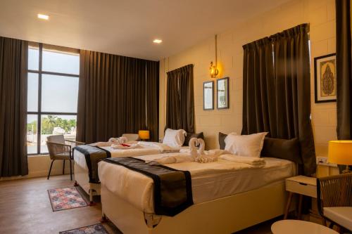 a hotel room with two beds in a room at Hotel Chandan Heritage in Bhubaneshwar
