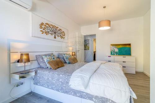 Giường trong phòng chung tại Pearl Sesimbra