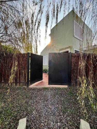 a gate in front of a house with a fence at La Casita in San Antonio de Areco