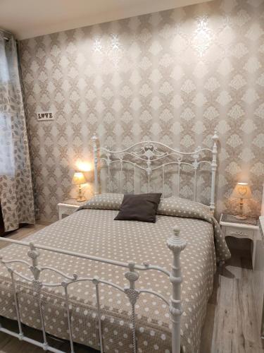 a bedroom with a bed with a silver bed frame at Casale dei Villa villa with pool and private parking in Ciampino