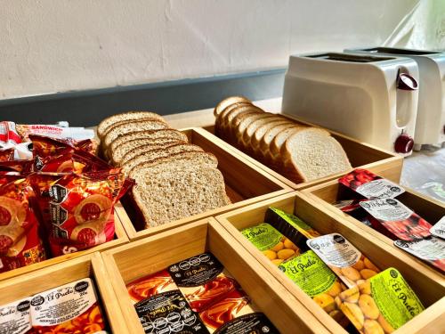 a drawer full of different types of bread and a toaster at Alpino Hotel in Buenos Aires