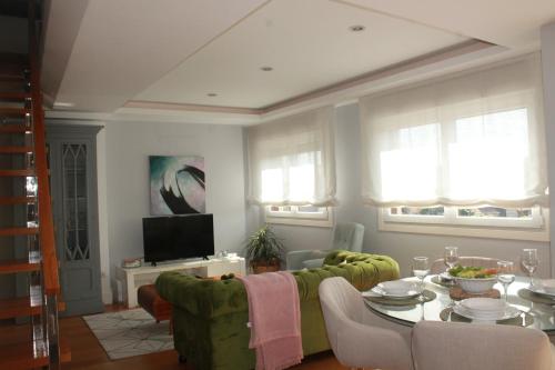 a living room with a couch and a table at Bournacell 16 in Cambados