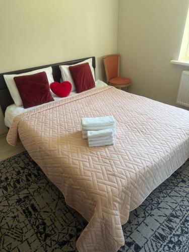 a bedroom with a bed with two towels on it at Palanga Green Hill in Palanga