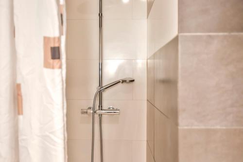 a shower with a glass door in a bathroom at Montroig Mar in Sitges