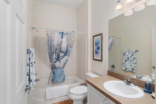a bathroom with a sink and a toilet and a tub at The Villages Courtyard Villa, Golf Cart, Private Yard, Prime Location in The Villages