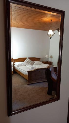 a mirror reflection of a bed in a bedroom at Penzion Ztracený mlýn in Slapy