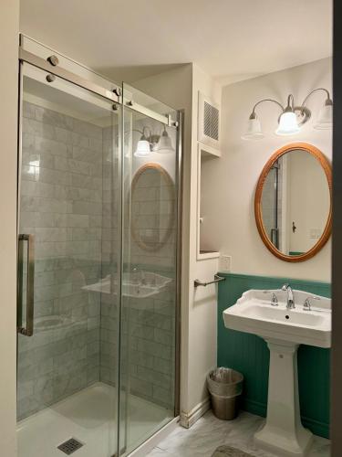a bathroom with a glass shower and a sink at Blue Cypress in Tofino