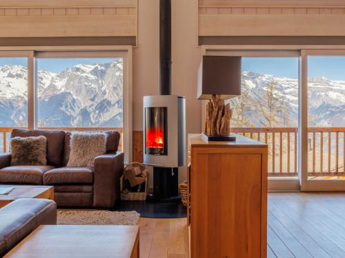 a living room with a view of mountains at Chalet Chalet Roose by Interhome in Plan Fey