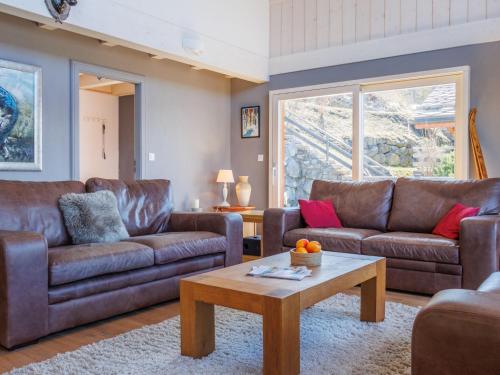 a living room with brown leather couches and a coffee table at Chalet Chalet Roose by Interhome in Plan Fey