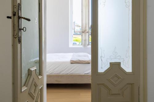 a door leading to a bedroom with a bed at Nel Blu in Menaggio
