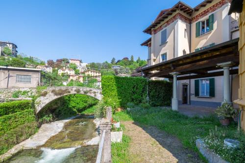 an old bridge over a river in a town at Nel Blu in Menaggio