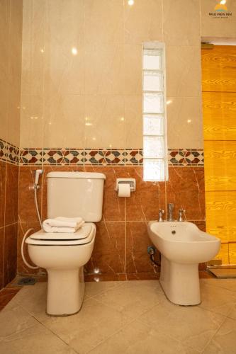 a bathroom with a toilet and a sink at Nile View Inn in Cairo