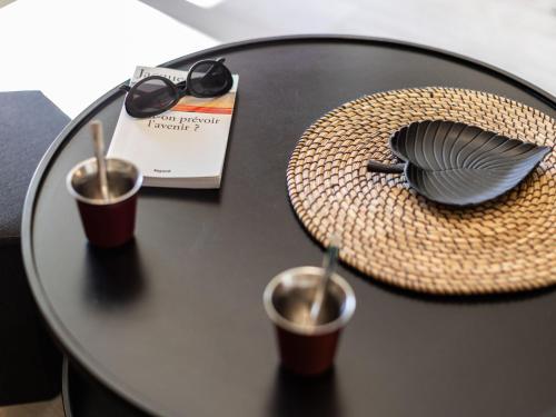 a table with two cups and a hat on it at Apartment Maïtena by Interhome in Bidart