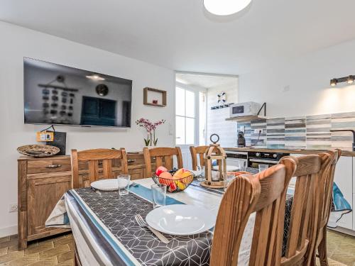 a kitchen with a table and chairs and a kitchen with a stove at Holiday Home La main d'argent by Interhome in Saint-Méloir-des-Ondes